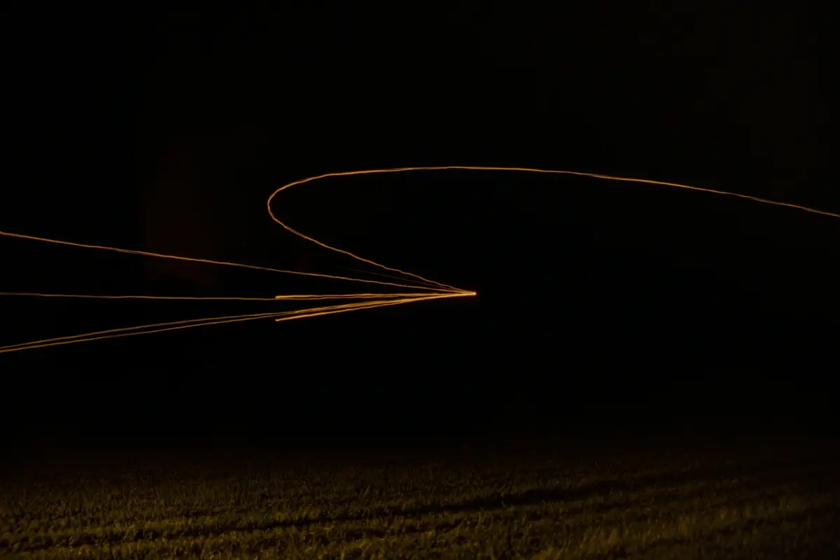 Long-exposure amber light trails converging to a point